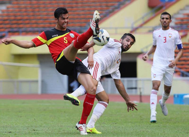 Ramon De Lima Saro of East Timor (L) fights for the ball with Ali Ahmed Mabkhout of the UAE during the 2018 FIFA World Cup football qualifying match between East Timor and the UAE at Shah Alam Stadium in Shah Alam, outside Kuala Lumpur on June 16, 2015. AFP PHOTO / KAMARUL AKHIR