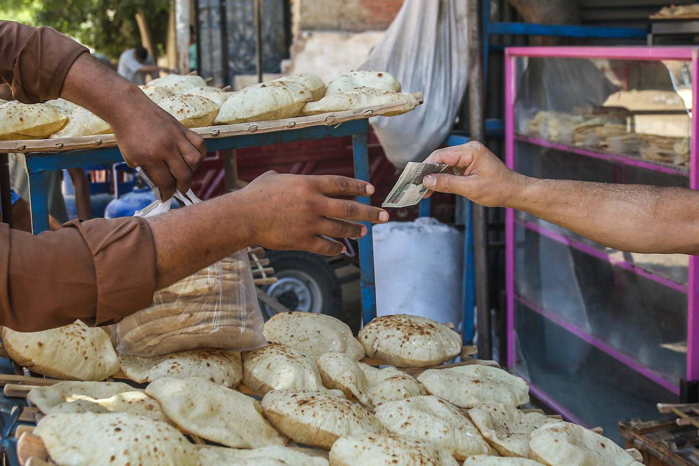 A customer buying bread in Egypt. Bloomberg