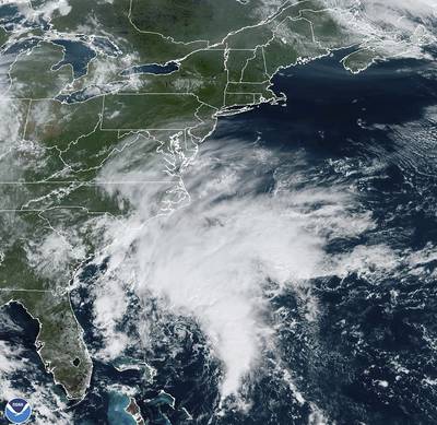 A satellite image provided by the National Oceanic and Atmospheric Administration shows a storm forming off the south-eastern coast of the US. AP