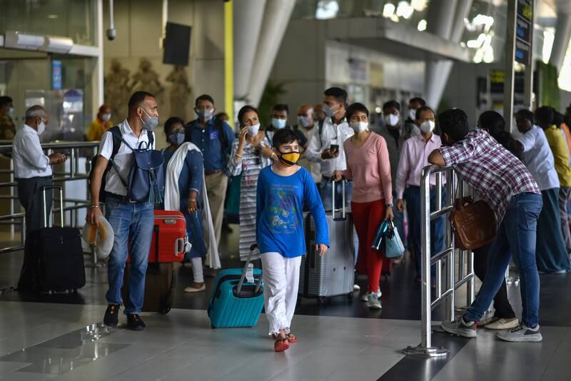 International air passengers arrive at Chennai International Airport on March 27, 2022. Regular international passenger flight services to and from India have resumed after two years of suspension because of the coronavirus pandemic. EPA