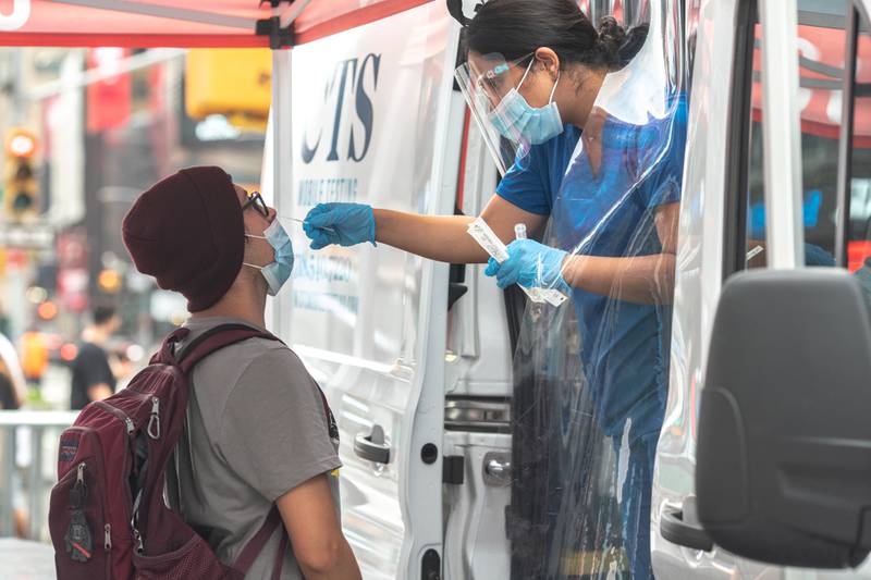A nasal swab for a Covid-19 test is administered at a mobile testing site in Times Square in New York City. Reuters