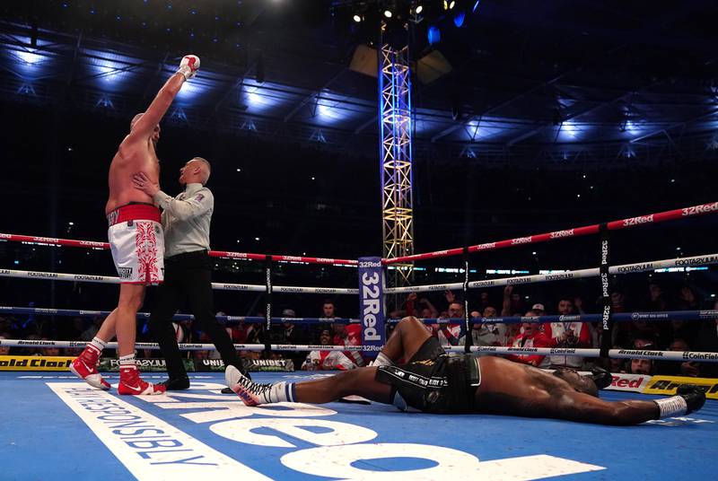 Tyson Fury celebrates after knocking down Dillian Whyte during their WBC heavyweight title fight. PA