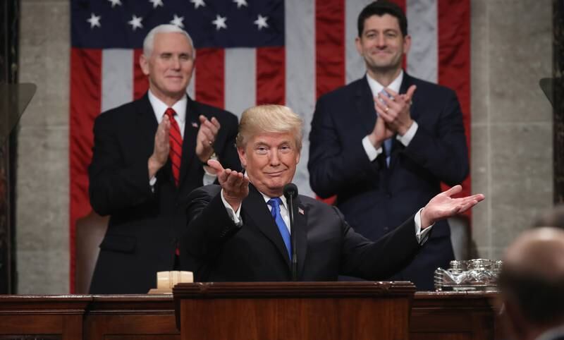 US President Donald  Trump delivers the State of the Union address as US Vice President Mike Pence (L) and Speaker of the House US Rep. Paul Ryan (R-WI) (R) look on in the chamber of the US House of Representatives in Washington, DC, on January 30, 2018. (Photo by Win McNamee / POOL / AFP)