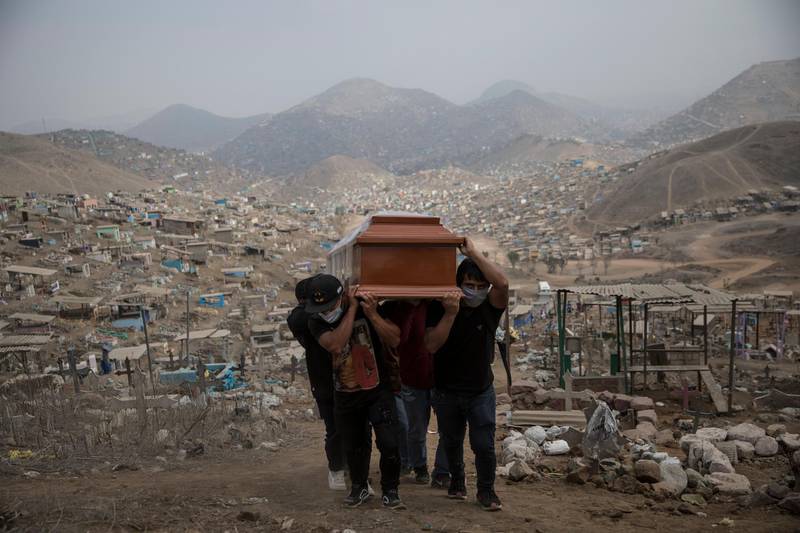 Relatives carry the coffin of a suspected COVID-19 victim at the Nueva Esperanza cemetery on the outskirts of Lima, Peru. AP Photo