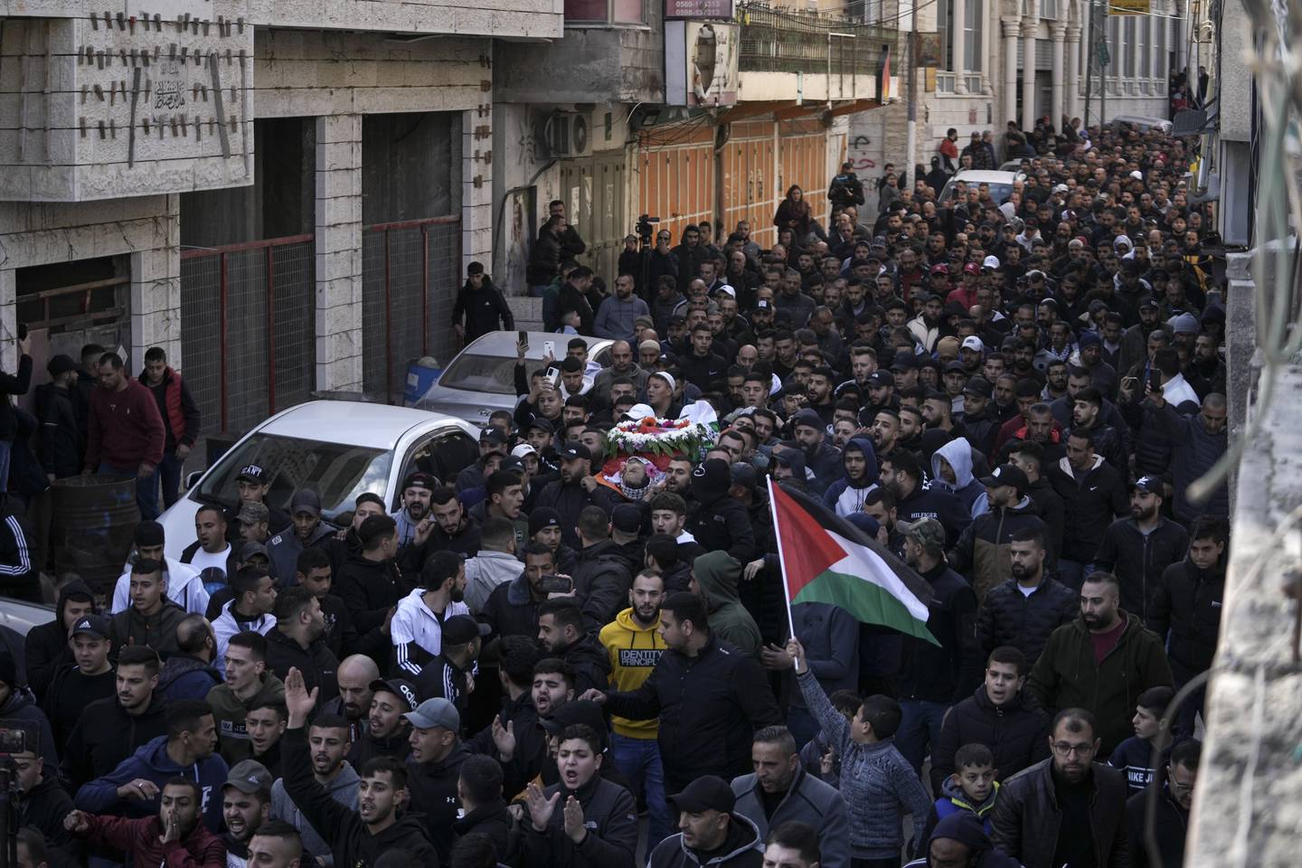 Mourners carry the body of Palestinian Samir Aslan, 41, in the Qalandia refugee camp on Thursday. AP