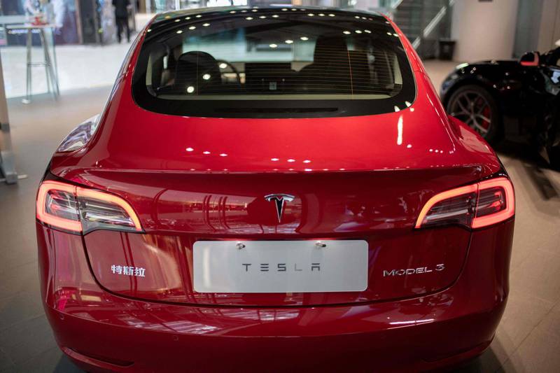 The back of a Tesla car Model 3 is seen at a Tesla shop inside of a shopping Mall in Beijing on May 26, 2021.  / AFP / NICOLAS ASFOURI
