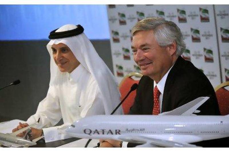 Akbar Al Baker, left, the chief executive of Qatar Airways, and John Leahy, the chief operating officer of Airbus, announce an order for 50 A320neo and five A380 aircraft valued at $6.4 billion at the Dubai Airshow yesterday. P Pigeyre / EPA