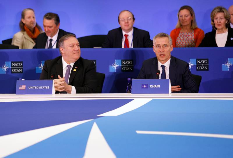 epa07484781 US Secretary of State Mike Pompeo (L) looks on as NATO Secretary General Jens Stoltenberg (R) delivers remarks during the meeting of the North Atlantic Council (NAC) in the Foreign Minister's session at the State Department in Washington, DC, USA, 04 April 2019. President Trump and Congress have hosted NATO Secretary General Jens Stoltenberg this week as foreign ministers gather in Washington for meetings.  EPA/TOM BRENNER