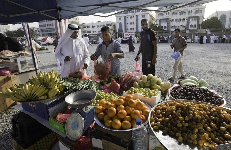 A resident stocks up with greens at a stall offering traditional fruits and vegetables at the Ramadan food carnival in Fujairah. Jaime Puebla / The National 