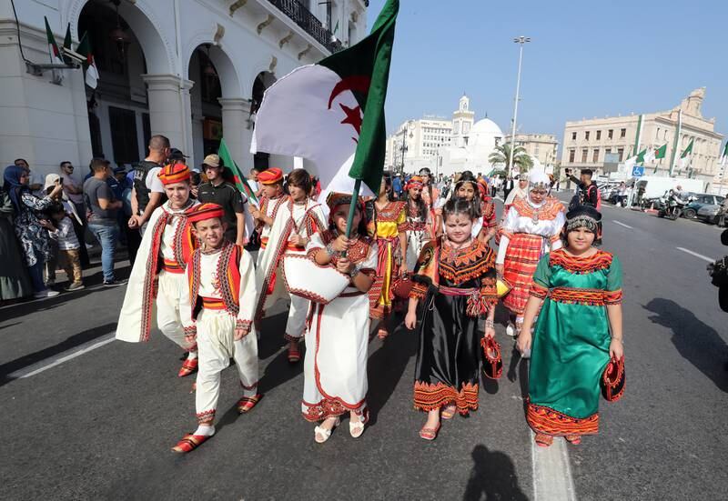 Algerian children carry the country's flag during the celebrations in Algiers. EPA