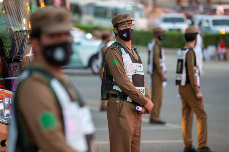 Security officers wear protective masks.  REUTERS