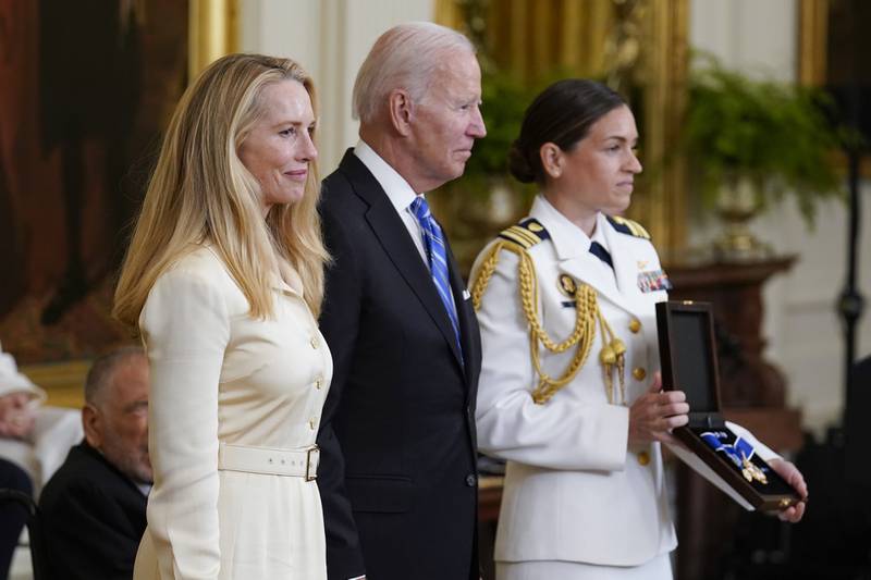 Mr Biden stands with Laurene Powell Jobs as he awards the Presidential Medal of Freedom to Apple co-founder Steve Jobs, her late husband. AP