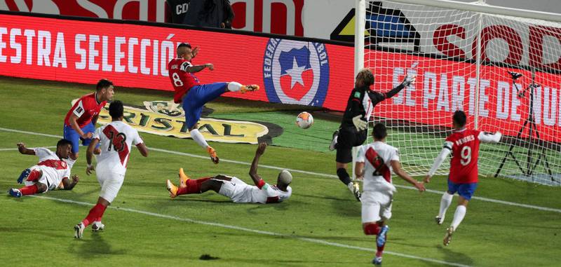 Chile's Arturo Vidal, centre above, scores his side's second goal in their 2-0 victory against Peru during the World Cup qualifier in Santiago on Friday, November 13. AP