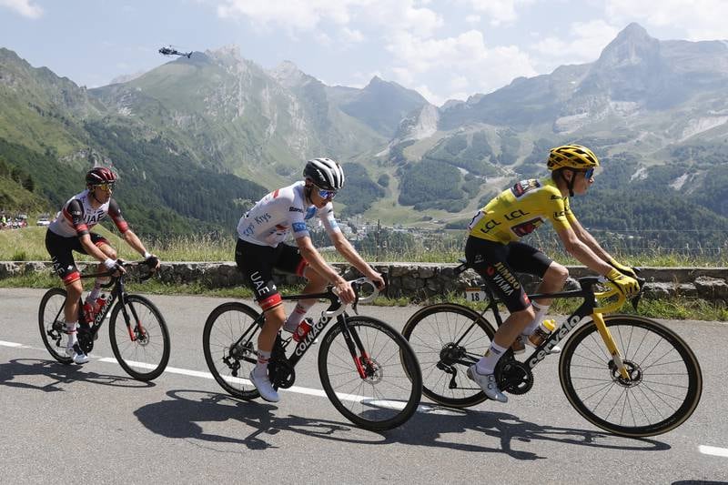 The Yellow Jersey rider Jonas Vingegaard, right, of Jumbo Visma and Tadej Pogacar, centre, of UAE Team Emirates in action during the 18th stage of the Tour de France, over 143. 2km from Lourdes to Hautacam. EPA