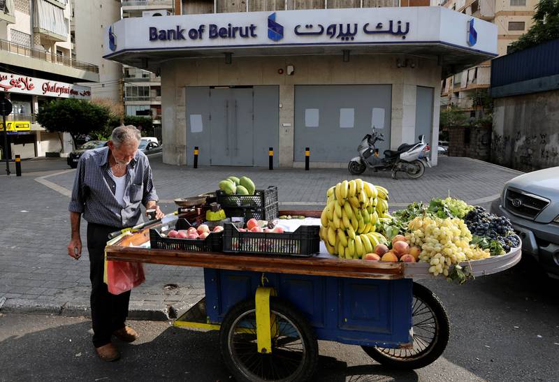 A street vendor stands by his cart near a closed Bank of Beirut branch in Beirut, Lebanon. Reuters