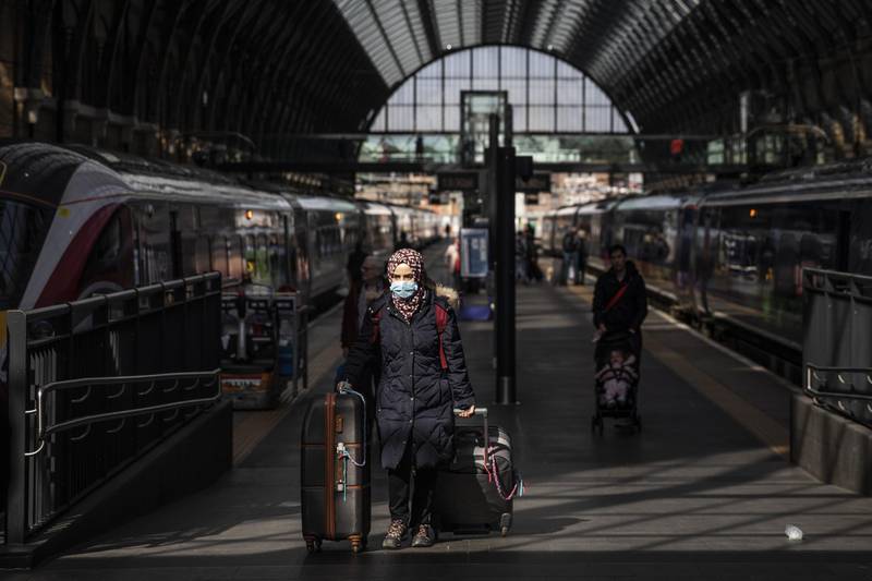 A passenger wears a protective mask at King's Cross train station on March 16, 2020 in London, England. Getty Images
