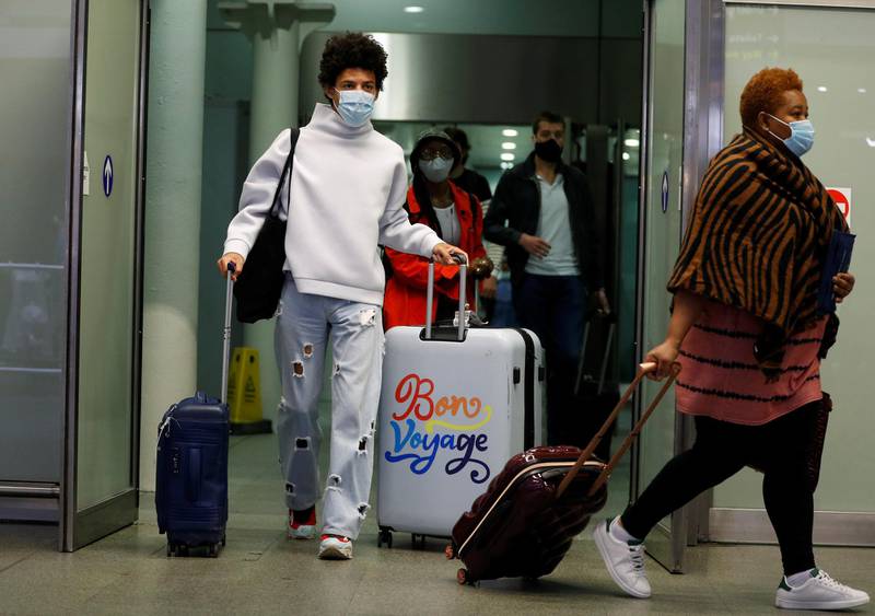 Passengers wearing protective face masks arrive from Paris at Eurostar terminal at St Pancras station, as Britain imposes a 14-day quarantine on arrival from France from Saturday, following the outbreak of the coronavirus disease (COVID-19), in London, Britain August 14, 2020. REUTERS/Peter Nicholls