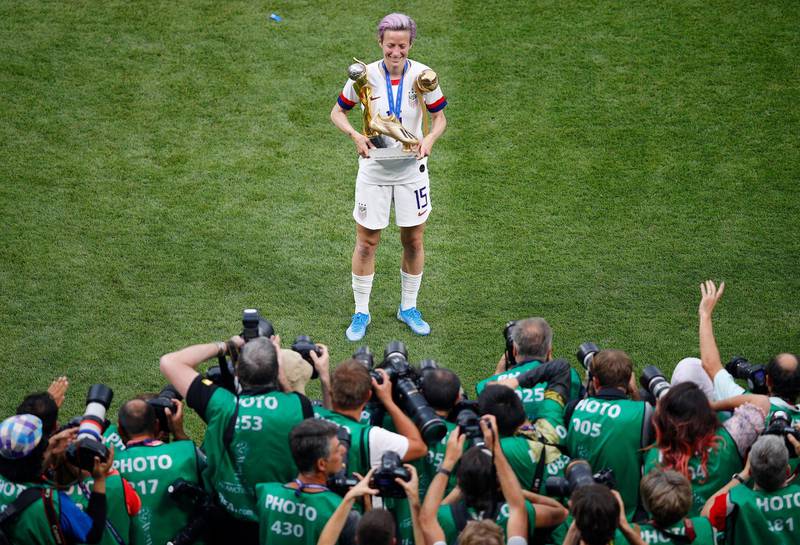 Rapinoe poses in front of photographers. AP Photo