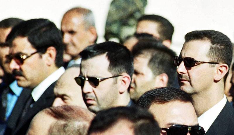 The Syrian president, Bashar Al Assad, right, his brother Maher, centre, and their brother-in-law, Assef Shawkat, left, at the funeral of the former Syrian president, Hafez Al Assad, in Damascus. AP Photo