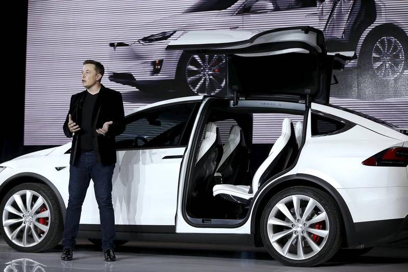 Tesla Motors' chief executive Elon Musk unveils the falcon wing door on the Model X electric 4x4. The 'offroader' outpaces the McLaren 675LT. Stephen Lam / Reuters