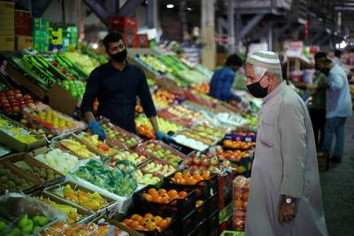 A Bahraini man wears a protective face mask following the outbreak of the coronavirus disease, as he shops at a vegetables market. Reuters