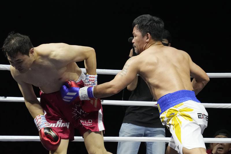 Manny Pacquiao lands a body shot on DK Yoo during the fourth round of their exhibition match. AP
