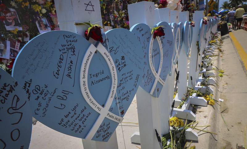 Wooden hearts with the names of the victims are erected at the memorial site. The Miami Herald / AP