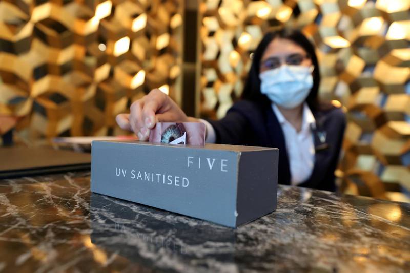 Dubai, United Arab Emirates - N/A. News. Coronavirus/Covid-19. A Five hotel employee puts room key through Ultra Violet sanitiser. Thursday, September 10th, 2020. Dubai. Chris Whiteoak / The National