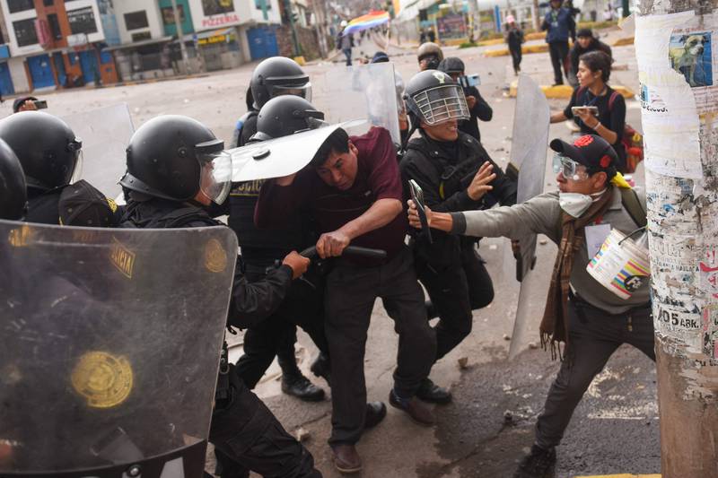 Protesters clash with members of the Peruvian riot police during a demonstration in the city of Cusco, Peru.  AFP