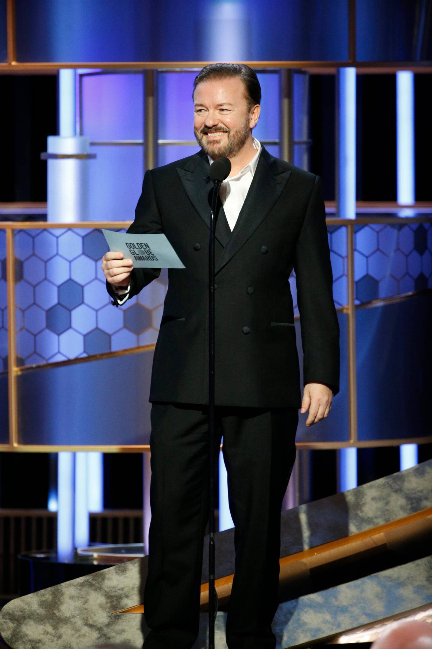 This image released by NBC shows host Ricky Gervais at the 77th Annual Golden Globe Awards at the Beverly Hilton Hotel in Beverly Hills, Calif., on Sunday, Jan. 5, 2020. (Paul Drinkwater/NBC via AP)