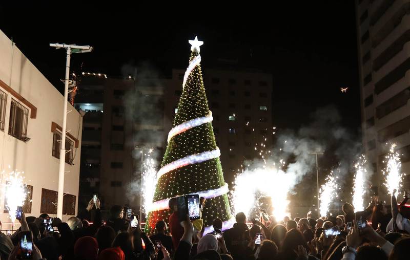 Palestinian Christians attend a Christmas tree lighting celebration on December 3, 2019 in Gaza City. / AFP / MAHMUD HAMS
