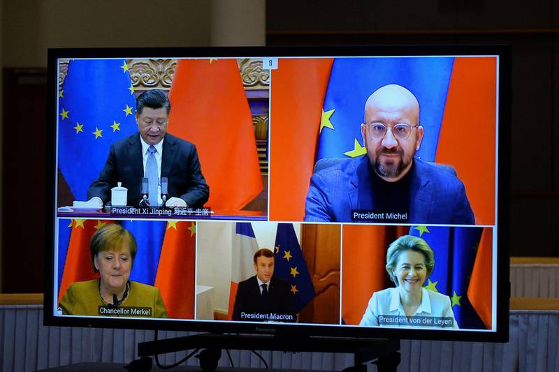 European Commission President Ursula von der Leyen, European Council President Charles Michel, German Chancellor Angela Merkel, French President Emmanuel Macron and Chinese President Xi Jinping are seen on a screen during a video conference, in Brussels, Belgium December 30, 2020. REUTERS/Johanna Geron/Pool