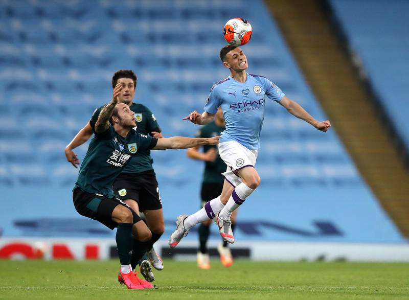 Manchester City's Phil Foden heads the ball away from Burnley's Josh Brownhill. AP Photo