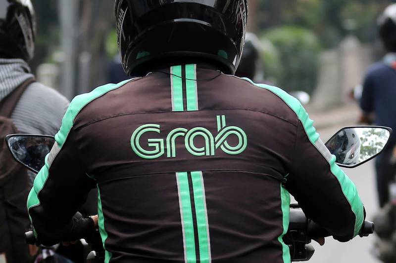 FILE - In this July 24, 2017, file photo, a GrabBike driver rides on his motorbike in Jakarta, Indonesia. Southeast Asiaâ€™s largest ride-hailing company, Grab Holdings, said Tuesday, April 13, 2021 that it plans to merge with U.S.-based Altimeter Growth Capital in a deal that would value it at nearly $40 billion in preparation for an initial public offering in the U.S. (AP Photo/Tatan Syuflana, File)