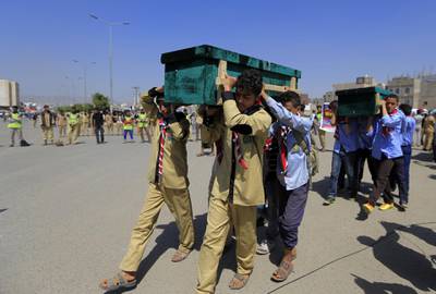 Yemeni children help carrying coffins of schoolchildren during a funeral in the capital Sanaa on April 10, 2019. Yemeni rebels held a mass funeral today for children killed in an explosion near two schools in the capital Sanaa. The explosion in the rebel-held Yemeni capital killed 14 children and wounded 16 others on April 7, the UN said. The cause remains unknown.
 / AFP / Mohammed HUWAIS
