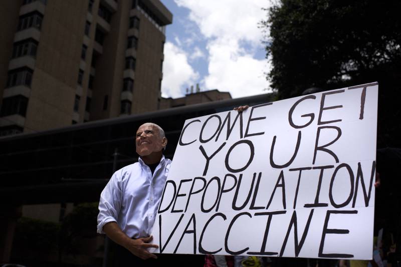 An anti-vaccine protester dressed up as Joe Biden holds a sign outside Houston Methodist Hospital in Texas last month. AFP