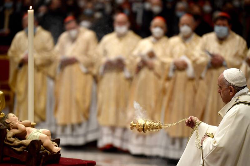 Pope Francis offers incense to a figurine of the infant Jesus before leading a Christmas Eve Mass at St Peter's Basilica in the Vatican. Photo: AFP