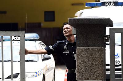 A police officer closes the main gate of the forensics wing of the Hospital Kuala Lumpur in the Malaysian capital, where the body of Kim Jong-nam, the half-brother of North Korean leader Kim Jong-un, is being kept. Manan Vatsyayana / AFP 