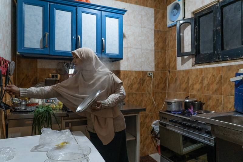 Noura Refaey, 43, an Egyptian housewife in her kitchen in Cairo's lower-income Talbia district. Noura is one of millions who have increased their intake of cheaper foods like lentils and other vegetables amid astronomical price increases particularly of meat and oils.