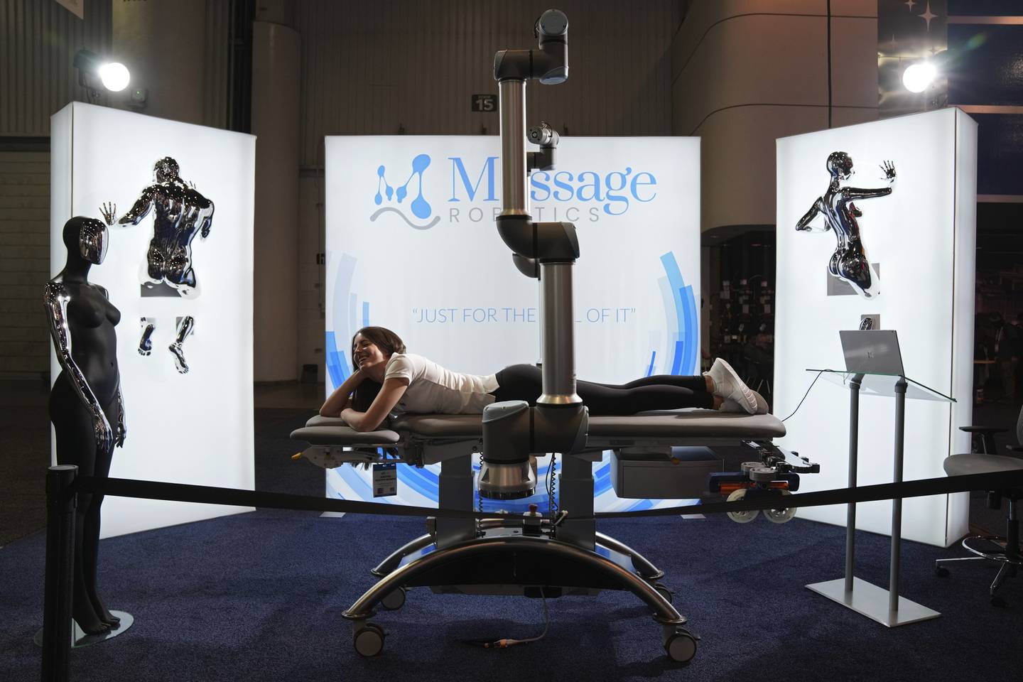 A woman lies on a robotic massage table at the Massage Robotics booth during the CES tech show in Las Vegas. AP
