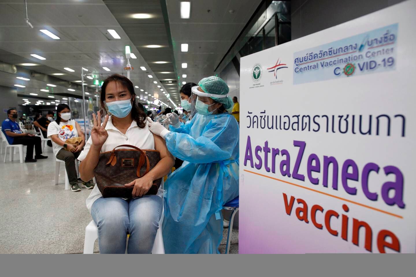 A Thai woman gestures while receiving a dose of AstraZeneca vaccine. Only a quarter of the population are vaccinated so far. EPA / Rungroj Yongrit
