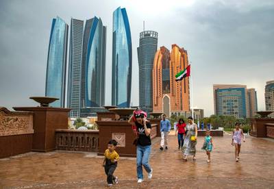 Abu Dhabi, United Arab Emirates - February 28th, 2018: People run for cover as the rain comes down. Wednesday, February 28th, 2018. Emirates Palace, Abu Dhabi. Chris Whiteoak / The National