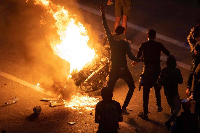 Migrants prevented from crossing the border from Morocco into the Spanish enclave of Ceuta burn a motorbike in protest in the northern town of Fnideq. AFP
