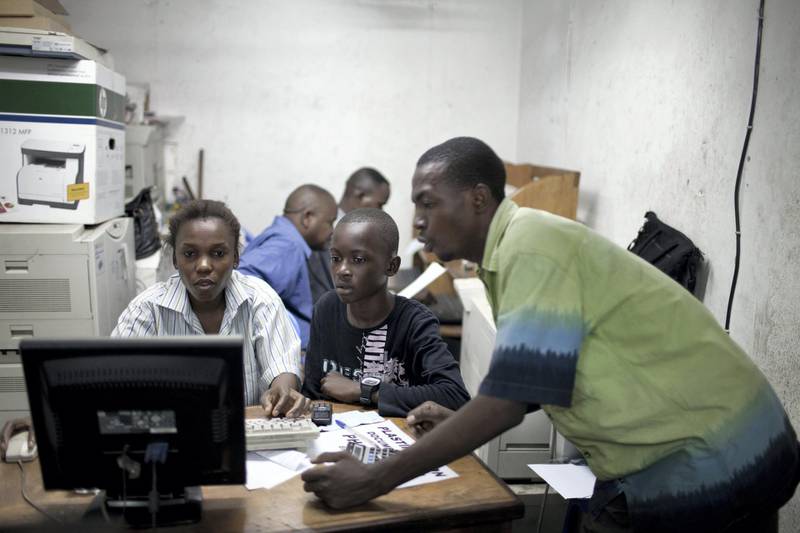 People use computers at an Internet cafe in Matonge district in Kinshasa, Congo, DRC.