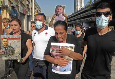 Relatives of Beirut port blast victims arrive for a remembrance ceremony at the site of the explosion on the first anniversary of the disaster.