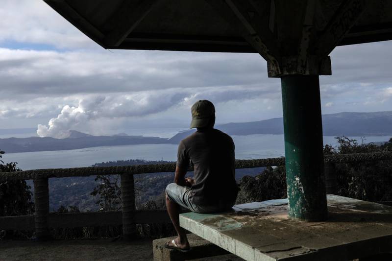 A man looks at the errupting Taal Volcano from a park in Tagaytay City, Philippines.  Reuters