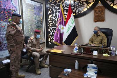 The prime minister met top military commanders as troops combed the fields around Tarmiyah. AFP