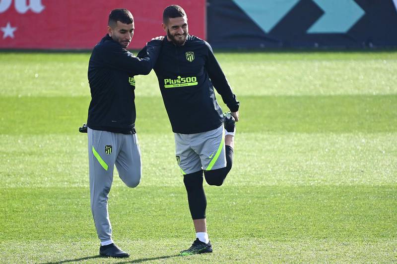 Atletico's Koke, left, and Angel Correa stretch during training. AFP