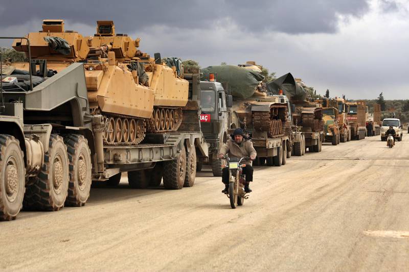 Turkish military convoy drives through the village of Binnish, in Idlib province, Syria. AP Photo