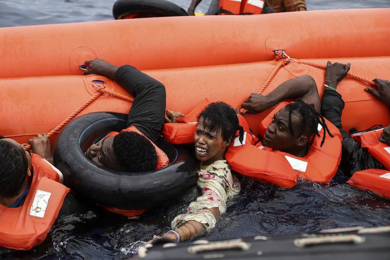 Migrants scramble to get to safety.